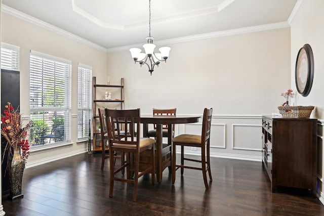 dining area featuring crown molding, a raised ceiling, and dark hardwood / wood-style floors