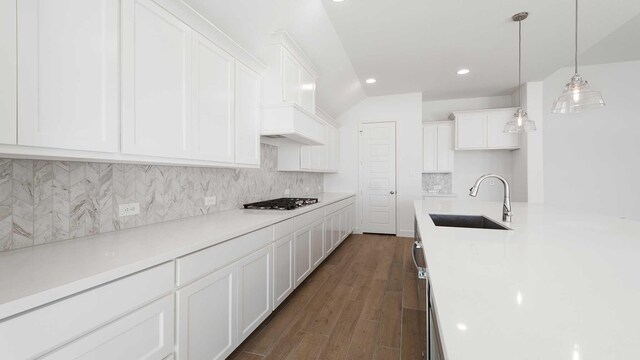 kitchen with sink, dark hardwood / wood-style floors, gas stovetop, white cabinets, and decorative light fixtures