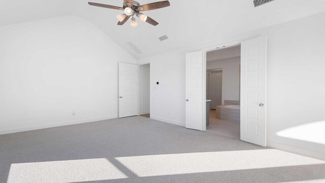 unfurnished bedroom featuring carpet, lofted ceiling, and ceiling fan