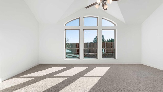 unfurnished room featuring high vaulted ceiling, ceiling fan, and carpet flooring