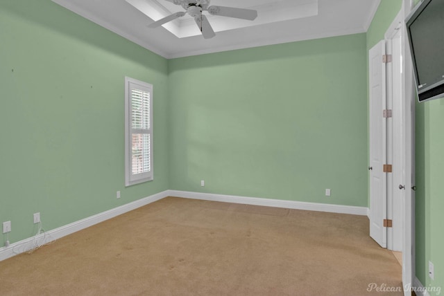 spare room featuring ceiling fan, ornamental molding, and light carpet