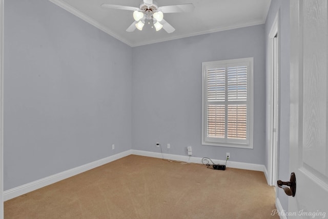 carpeted spare room featuring crown molding and ceiling fan