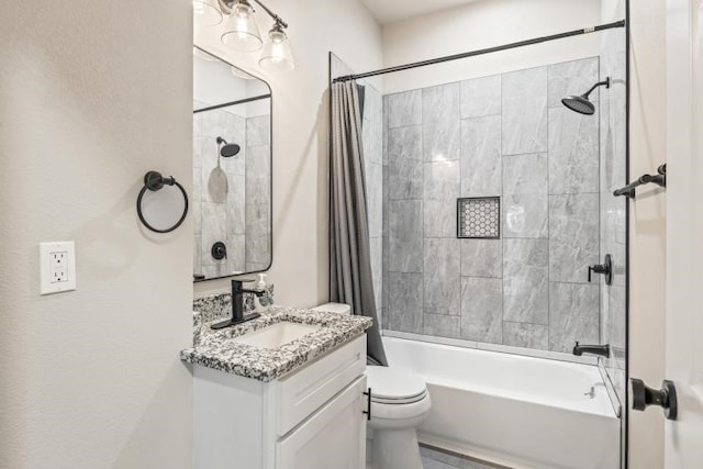 full bathroom with vanity, shower / tub combo, and toilet