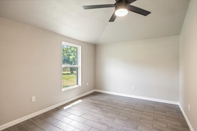 empty room featuring ceiling fan and vaulted ceiling