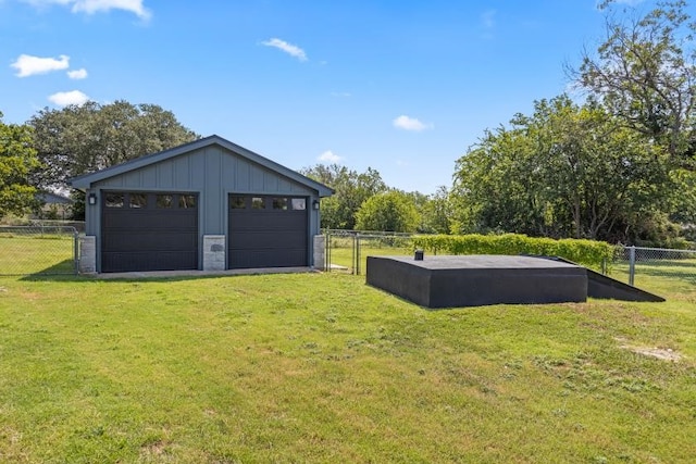 garage featuring a lawn