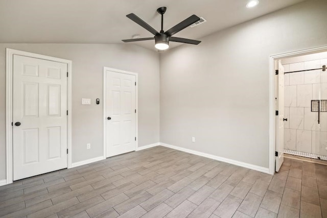 unfurnished room with wood-type flooring, ceiling fan, and lofted ceiling