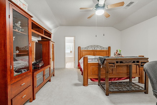 bathroom featuring dual vanity, tile patterned flooring, vaulted ceiling, and a tub to relax in