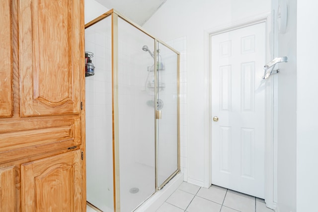 bathroom with tile patterned flooring and a shower with shower door