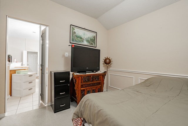 bedroom featuring light tile patterned floors and vaulted ceiling