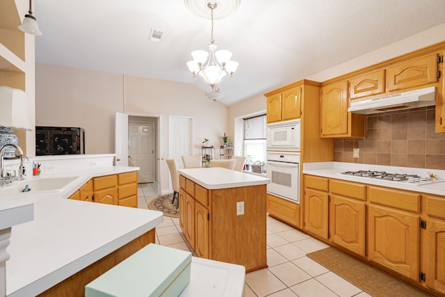 kitchen featuring pendant lighting, white appliances, sink, an inviting chandelier, and a center island