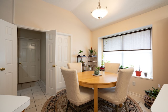 kitchen with white appliances, a center island, vaulted ceiling, light tile patterned floors, and backsplash