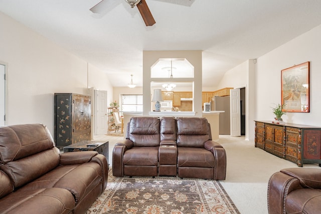 carpeted living room featuring vaulted ceiling and ceiling fan