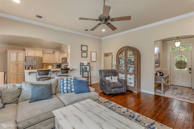 living room with dark wood-type flooring, ceiling fan, and ornamental molding