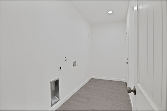 clothes washing area with hookup for a washing machine, hookup for an electric dryer, and hardwood / wood-style floors