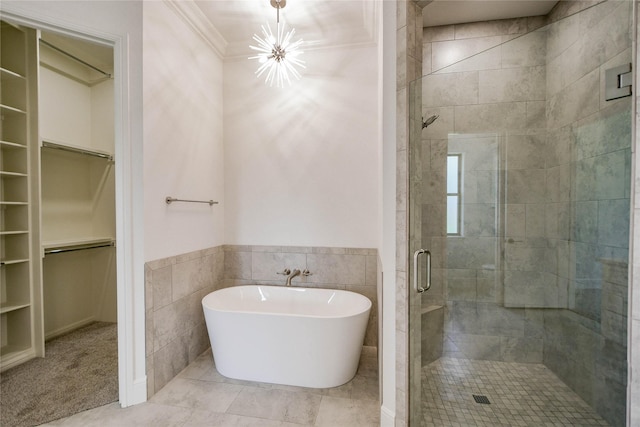 bathroom featuring tile walls, separate shower and tub, and an inviting chandelier