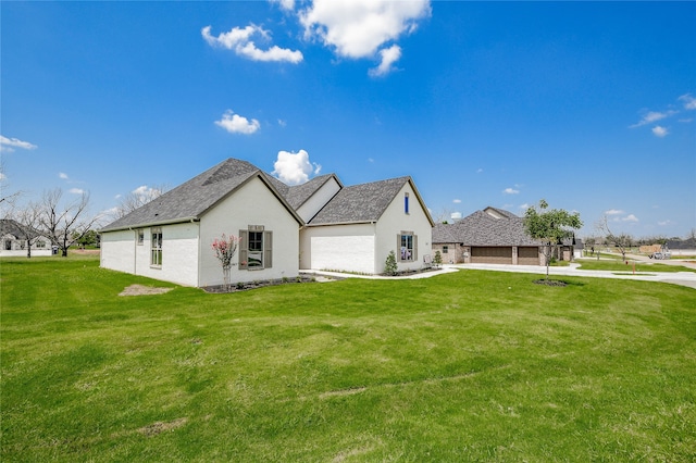 view of side of property with a garage and a lawn