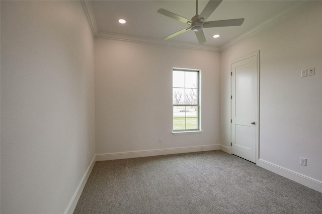 empty room with ceiling fan, ornamental molding, and carpet