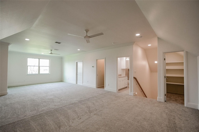 carpeted spare room with crown molding and ceiling fan