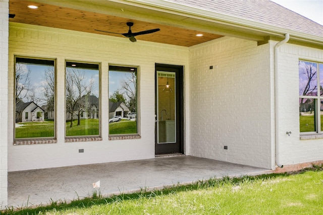 entrance to property featuring ceiling fan and a patio