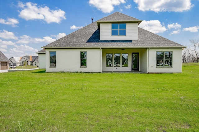 rear view of property with a yard