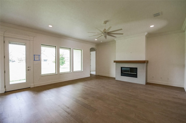 unfurnished living room with ceiling fan, ornamental molding, and dark hardwood / wood-style floors