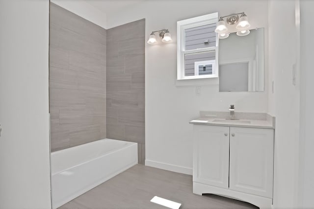 bathroom featuring vanity and tiled shower / bath