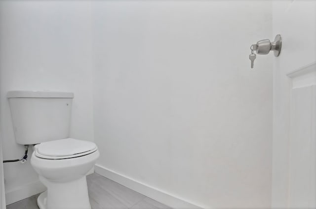 bathroom featuring tile patterned floors and toilet