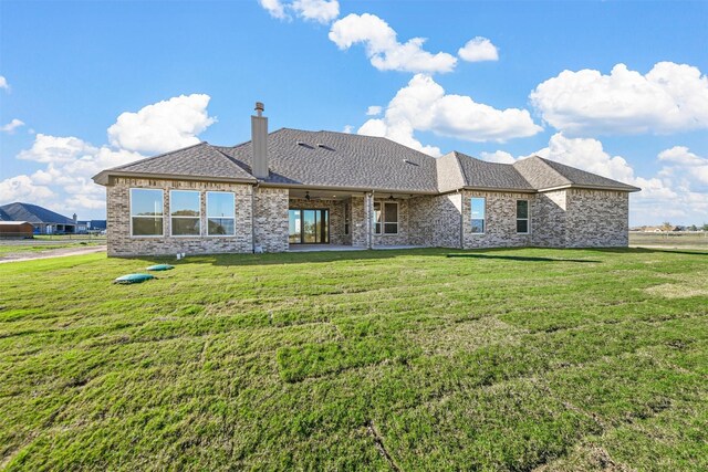 back of house with a lawn and ceiling fan