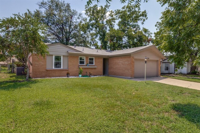 ranch-style home featuring a garage, central AC, and a front lawn