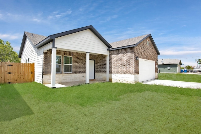 view of front of property with a garage and a front yard