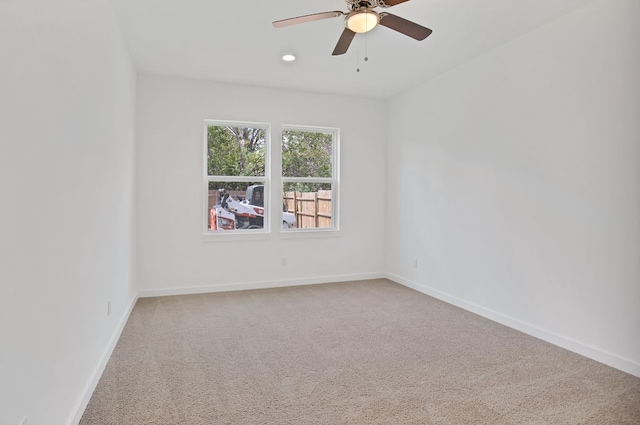 carpeted empty room featuring ceiling fan