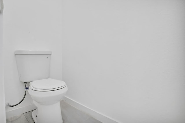 bathroom with tile patterned floors and toilet