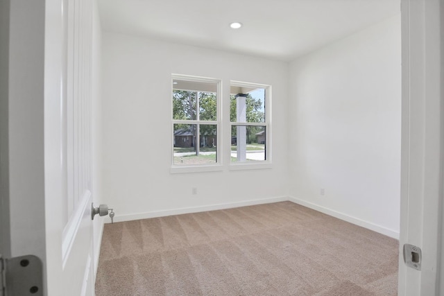 spare room with light colored carpet