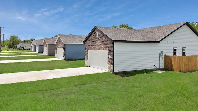 view of home's exterior featuring a garage and a lawn