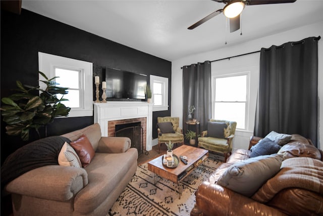 living room with a fireplace and ceiling fan