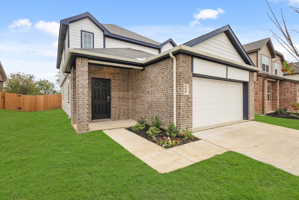 view of front of house featuring a garage and a front yard