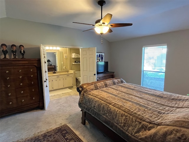 carpeted bedroom with ceiling fan, connected bathroom, and vaulted ceiling