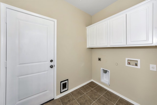 laundry room with cabinets, electric dryer hookup, gas dryer hookup, hookup for a washing machine, and dark tile patterned flooring