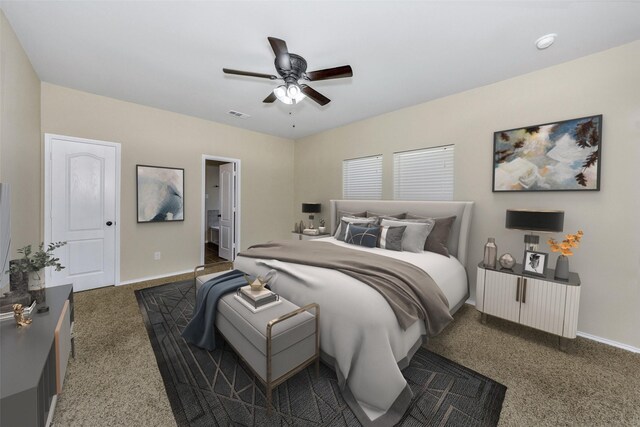 bedroom featuring ceiling fan, dark carpet, and ensuite bath