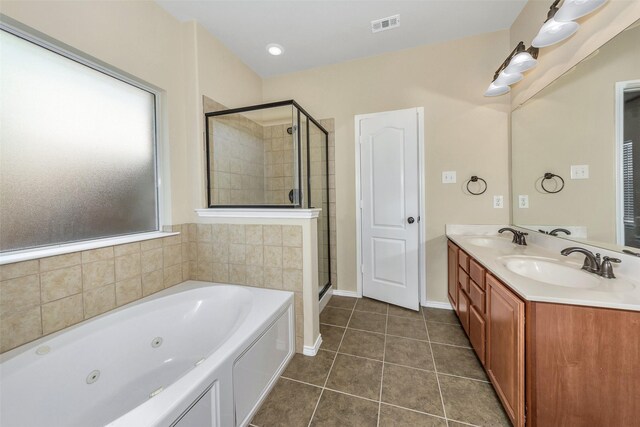 bathroom featuring vanity, tile patterned floors, and plus walk in shower