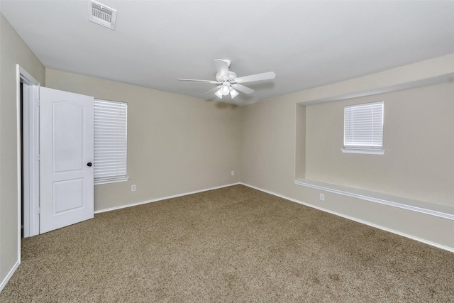 empty room featuring ceiling fan and dark hardwood / wood-style flooring