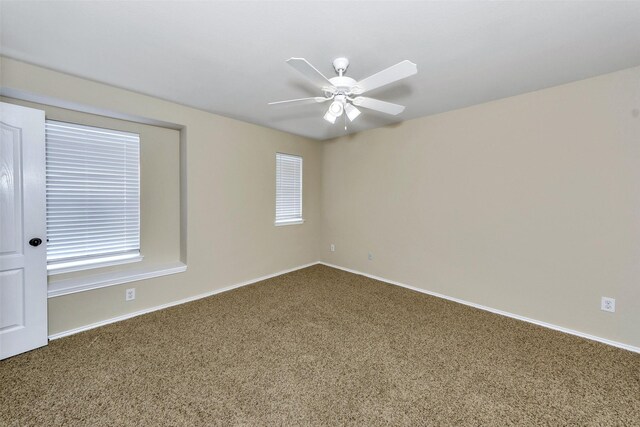 spare room featuring carpet flooring and ceiling fan