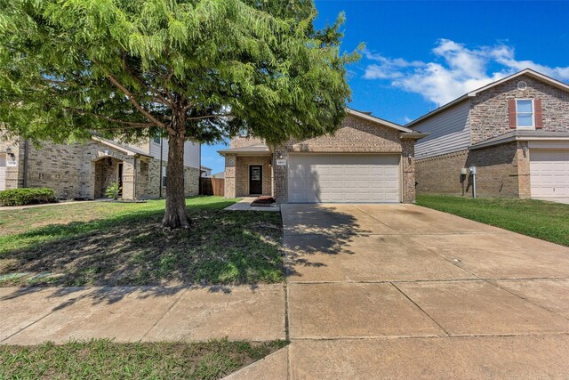 view of front of house with a front lawn and a garage