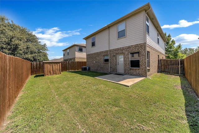 back of house featuring a yard, a patio, and central AC unit