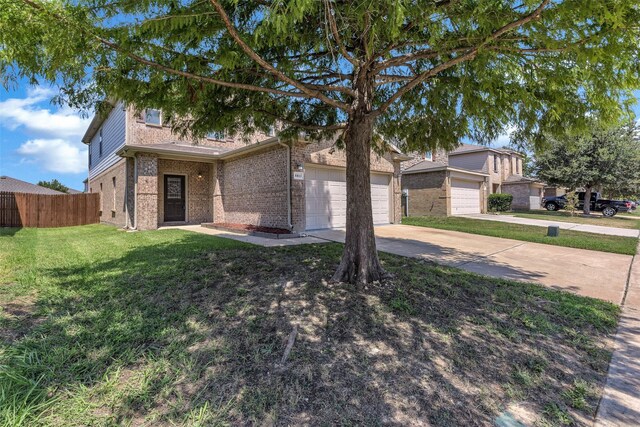 view of front of property with a front yard and a garage