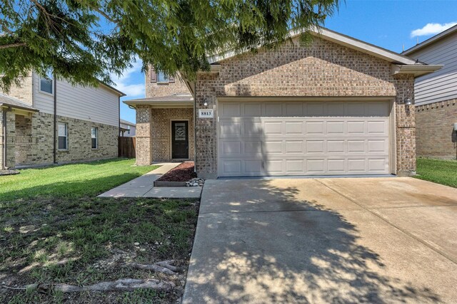 view of front of house featuring a front yard and a garage