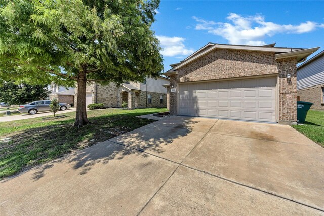 view of front of property featuring a garage and a front lawn