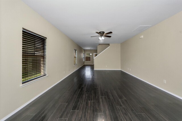 living room featuring ceiling fan and dark hardwood / wood-style flooring