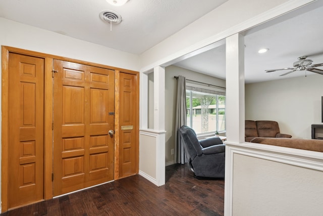 foyer entrance with dark wood-type flooring and ceiling fan