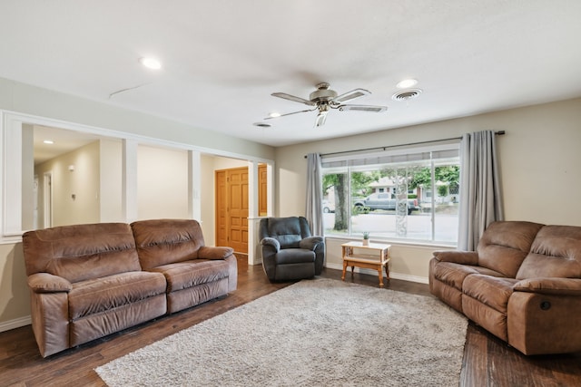 living room featuring dark hardwood / wood-style flooring and ceiling fan